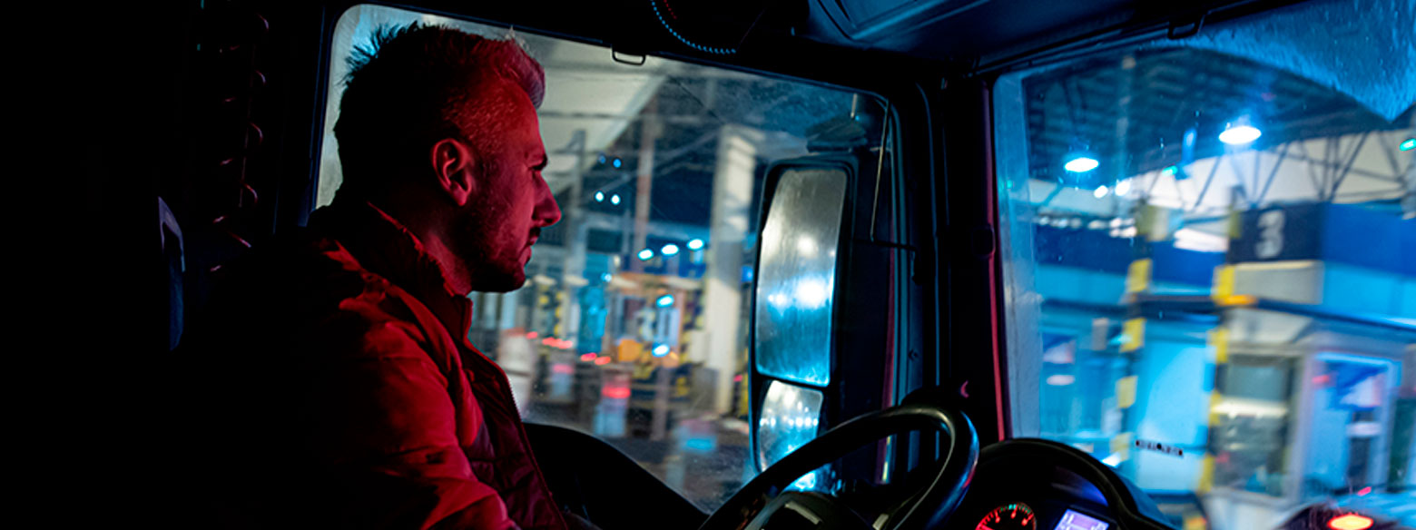 A trucker drives at night.