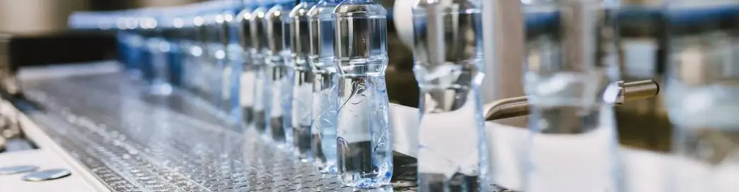 Water bottles moving on an automated assembly line.