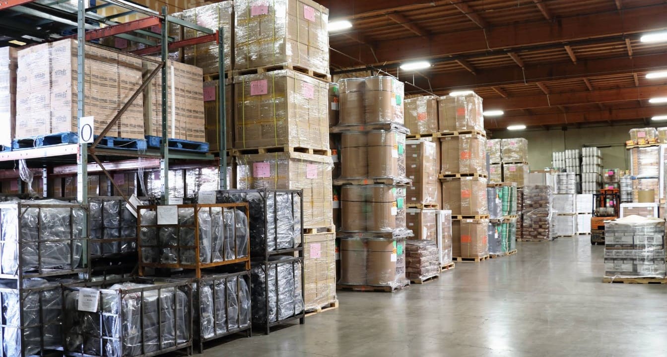 Organized pallet storage and packaged inventory inside American Warehouse